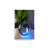 A Modern Art Glass Sphere Reflecting Neon Blue Light.