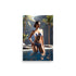 A hot brunette girl wearing a bikini in a pool, the palm trees add a tropical feel.