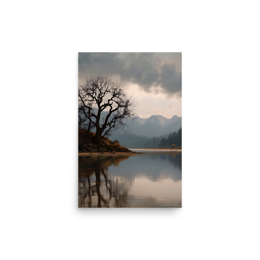 Beautiful lake encircled by mountains, forests. Glassy surface reflects peaks, gnarled shoreline tree. Branches silhouetted against dramatic cloudy overhead sky. Misty mountain hues create serene atmosphere. Inviting natural wonder prompts quiet contemplation.