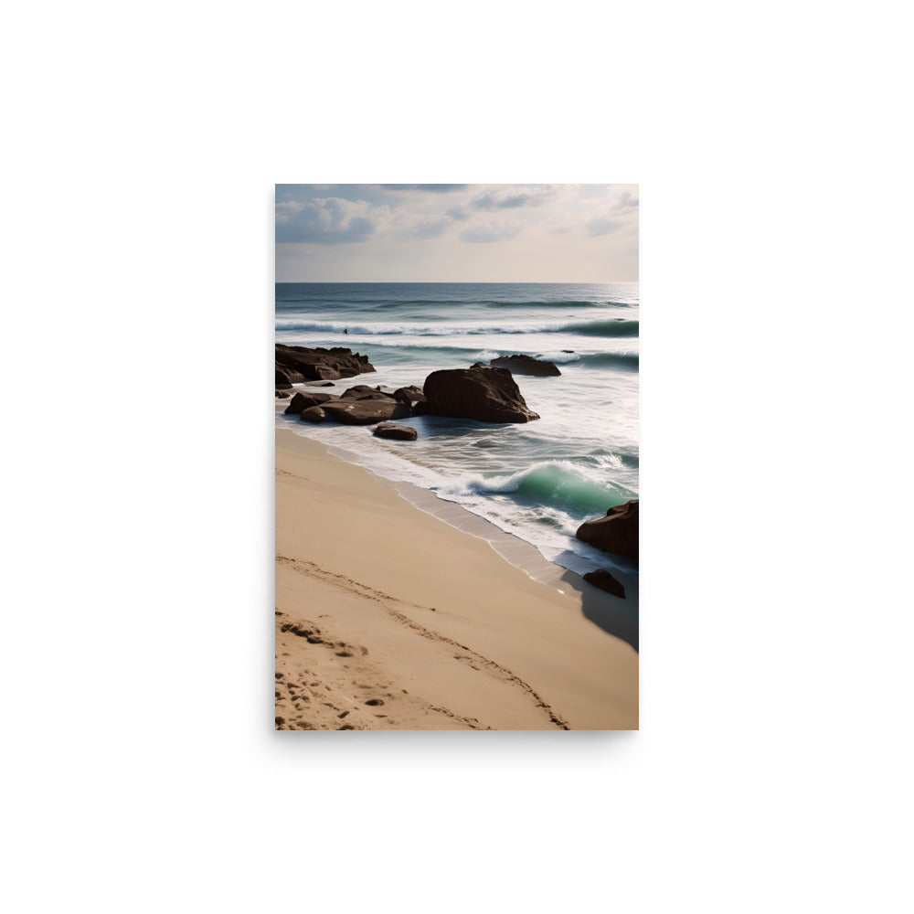 Golden sand adorned with footprints lines. Weathered rocks contrast smooth ocean waves. Blue-green waters reflect cloudy sky, creating. Dreamy ambiance invites peace and relaxation.