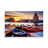 Rowboats on the water at sunset with an architectural structure, with a glowing sky.