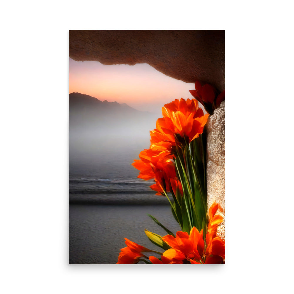 Vibrant orange flowers burst from rocks. Misty mountains rise majestically in distance. Tranquil waters mirror dazzling sunset sky. Delicate blooms contrast rugged terrain beautifully.