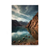 Mountains surround tranquil teal lake basin. Towering reddish cliffs face serene waters. Scattered shoreline rocks offer textural contrast. Dramatic cloudy skies create moody atmosphere.